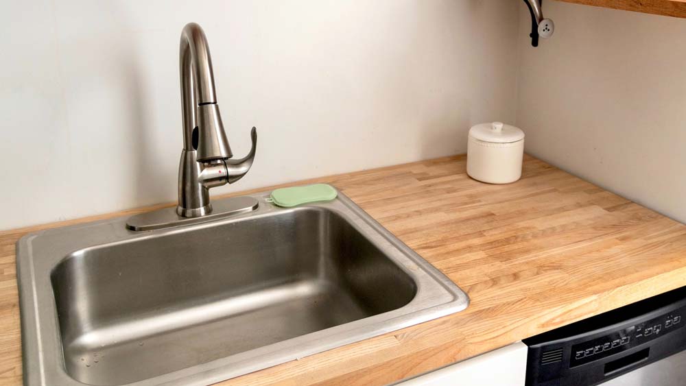 A kitchen sink with garbage disposal